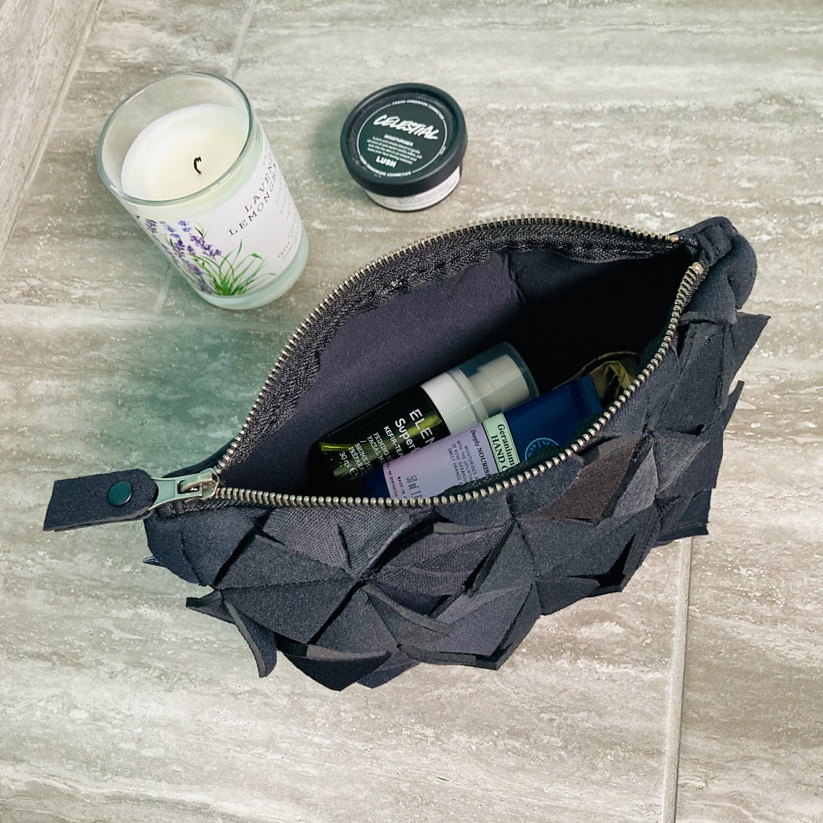 Recycled washbag with geometric texture pattern. Metal zipped closure. Made from recycled wetsuits.