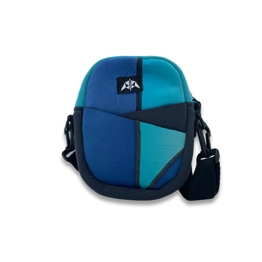 Zipped crossbody bag with zipped opening, adjustable strap and front slip pockets. In baby blue, bright blue and grey. Made from upcycled wetsuits