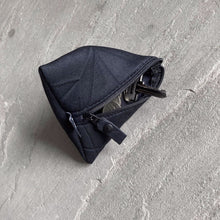 Load image into Gallery viewer, Trinity pyramid-shaped neoprene pouch in black with keys and coins inside
